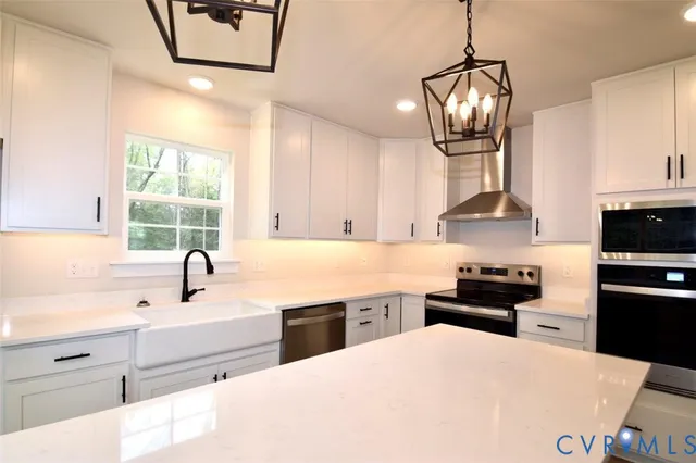 a kitchen with stainless steel appliances a sink stove and refrigerator