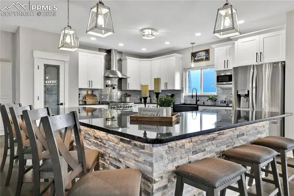 a large kitchen with a table and chairs