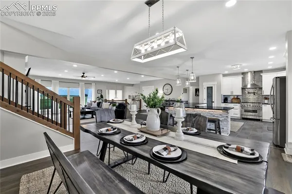 a view of a dining room with furniture a chandelier and wooden floor