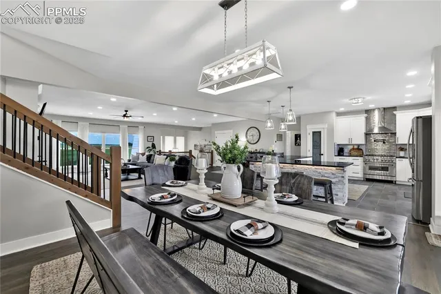 a view of a dining room with furniture a chandelier and wooden floor