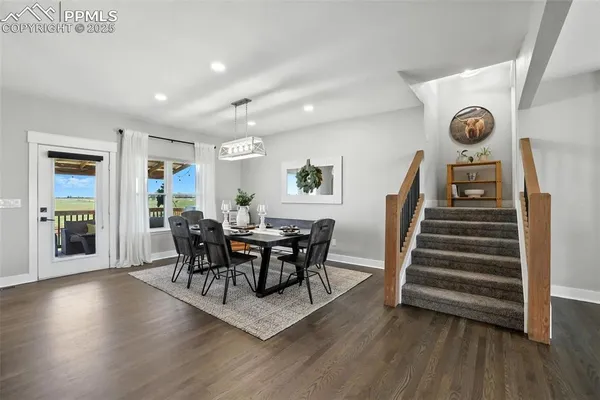 a view of a dining room with furniture and wooden floor