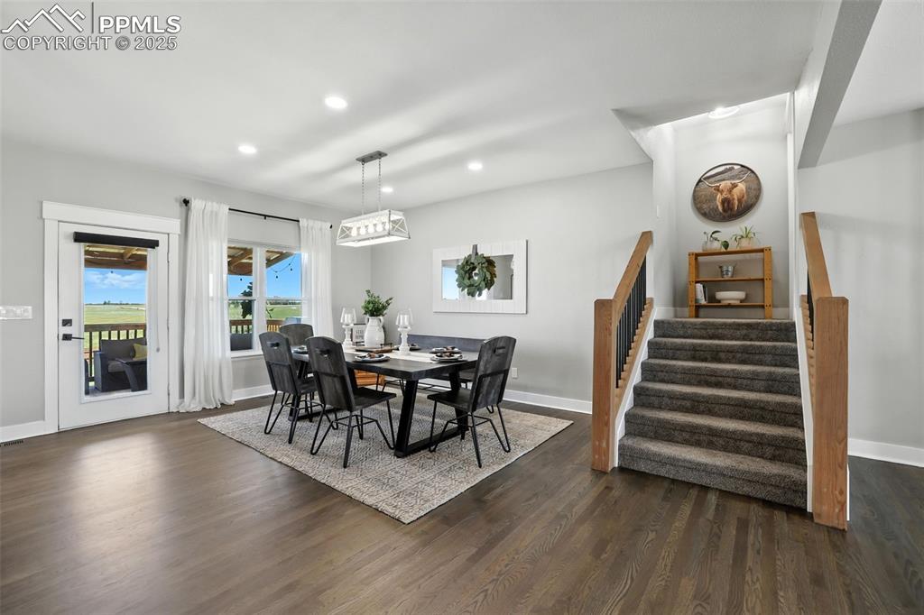 18135 Spur Ranch Road Peyton, CO 80831 - Photo 16 of 36 a view of a dining room with furniture and wooden floor
