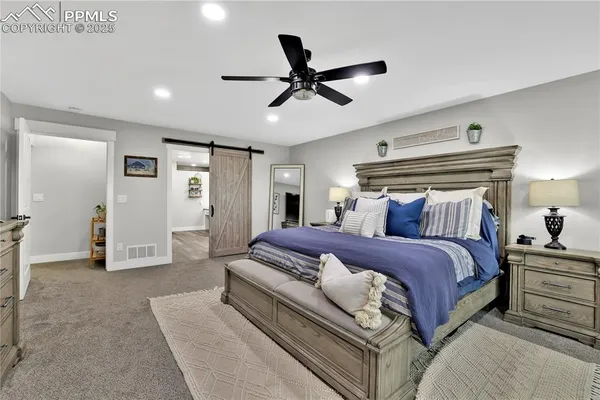 a spacious bedroom with a bed and closet
