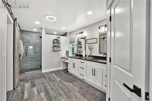 a bathroom with double vanity and a shower