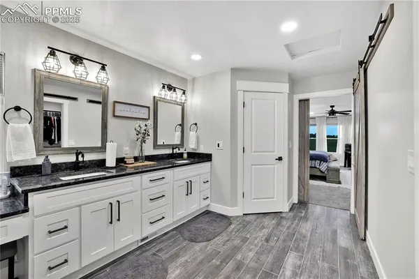 a spacious bathroom with a granite countertop sink mirror and a