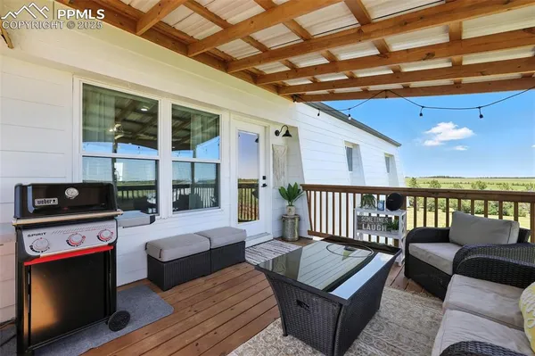 a living room with furniture and large windows