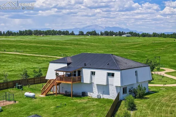 a aerial view of a house with a yard