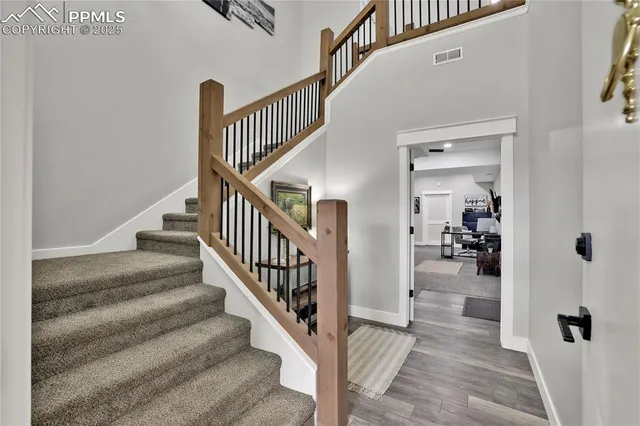 a view of entryway and hall with wooden floor