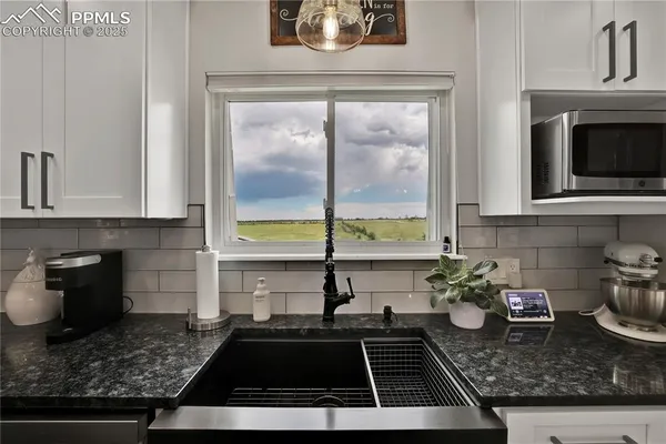 a kitchen with a stove a sink and a counter top space
