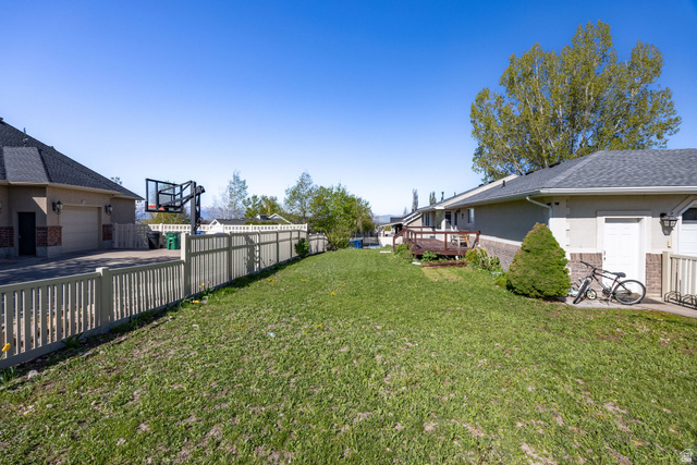 892 East 400 South Smithfield, UT 84335 - Photo 36 of 44 Fenced backyard with a wooden deck and a garage