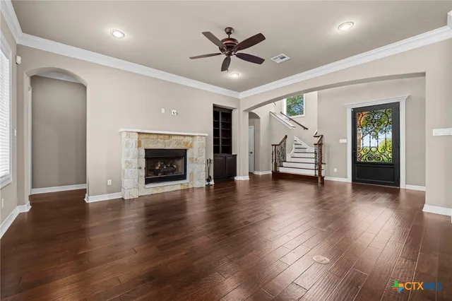a bathroom with a granite countertop bathtub sink vanity mirror and toilet