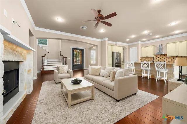 a view of a hallway with wooden floor and stairs