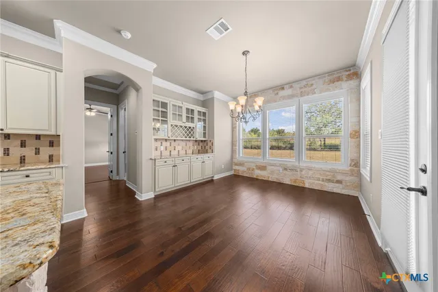 a view of entryway with wooden floor and stairs