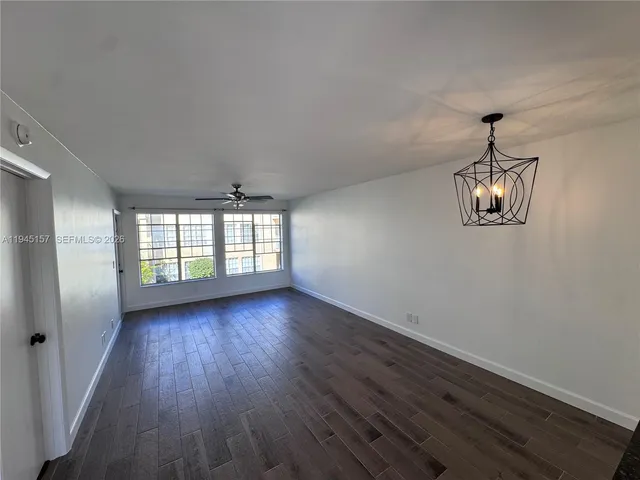 a kitchen with granite countertop a stove and a wooden floor