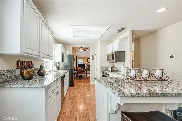 a kitchen with sink stove and cabinets