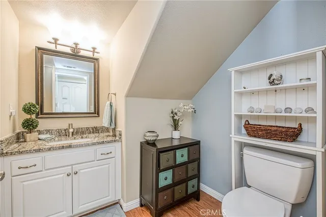 a bathroom with a toilet a sink and a mirror