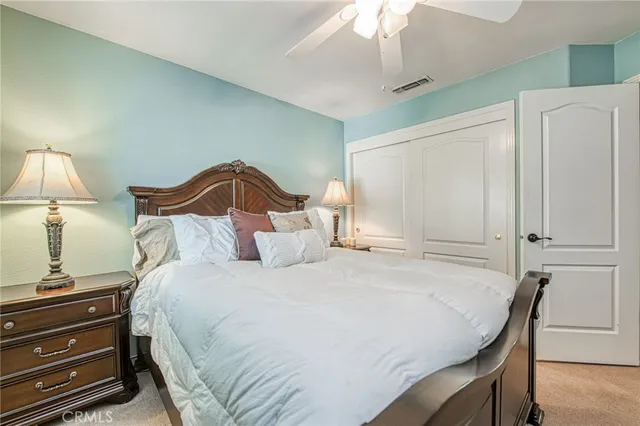 a bedroom with a bed and a lamp on table