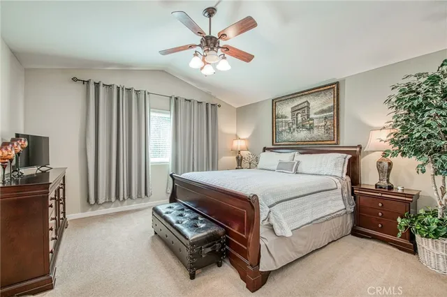 a bedroom with a bed next to a window and a potted plant