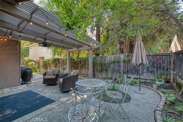 a view of a patio with couches table and chairs and potted plants