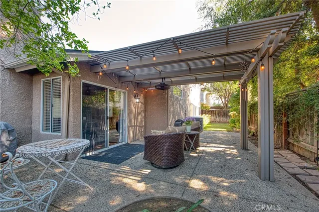 a view of a patio with table and chairs and potted plants