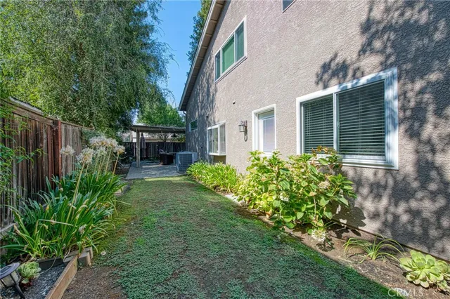 a view of house with backyard and a garden