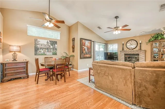 a living room with furniture a dining table and a fireplace
