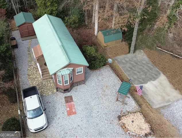 an aerial view of a house with garden space and street view