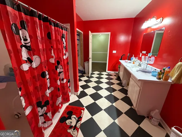 a bathroom with a sink a mirror and a shower