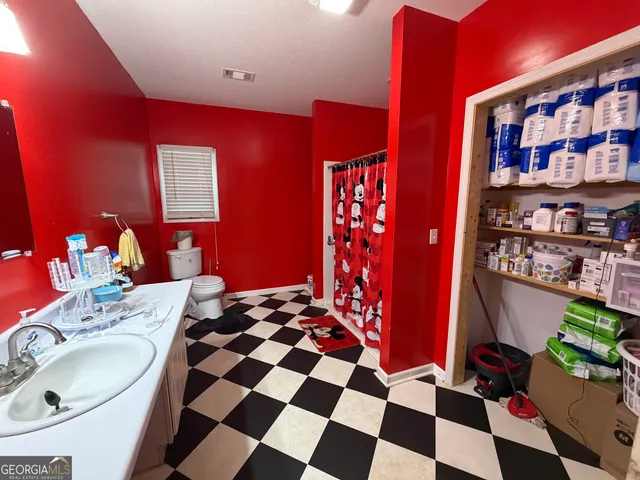 a living room with furniture and a painting on the wall