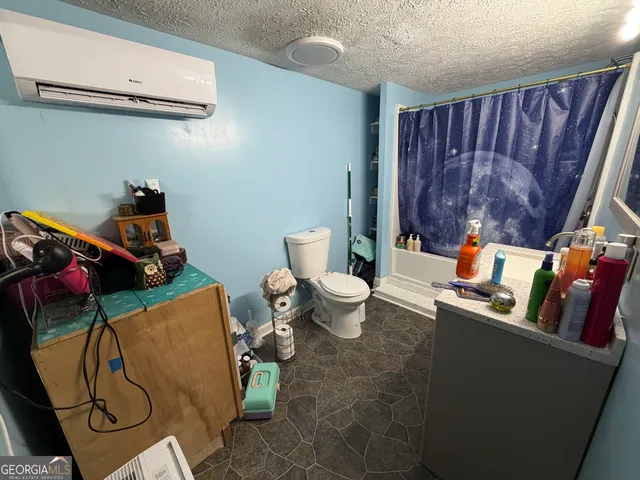 a bathroom with a toilet sink and mirror