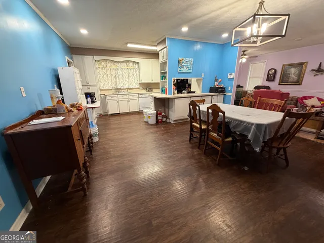 a living room with furniture a dining table and chairs with wooden floor
