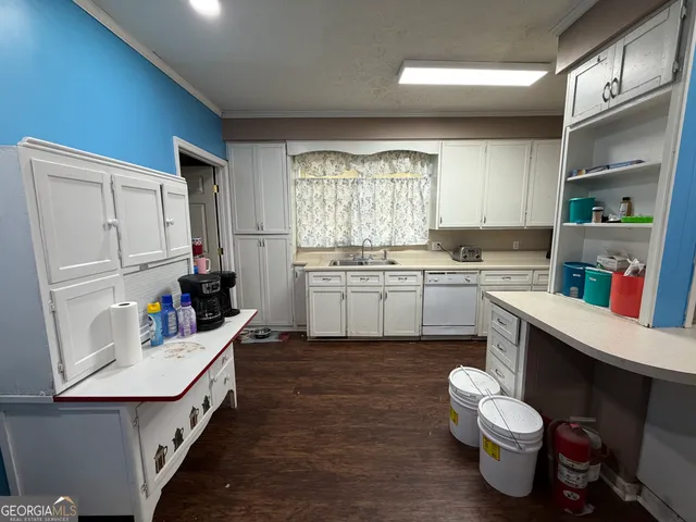 a kitchen with a sink stove and cabinets