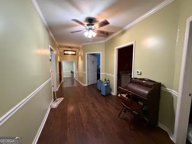 a view of a livingroom with furniture and a ceiling fan