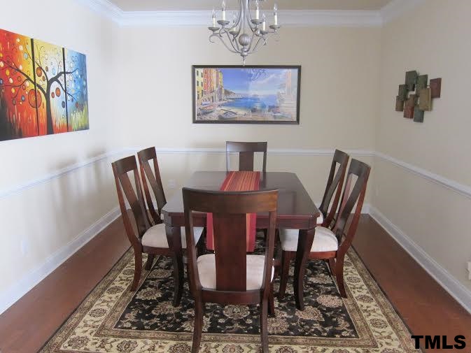 11238 Maplecroft Court Raleigh, NC 27617 - Photo 4 of 12 a view of a dining room with furniture and wooden floor