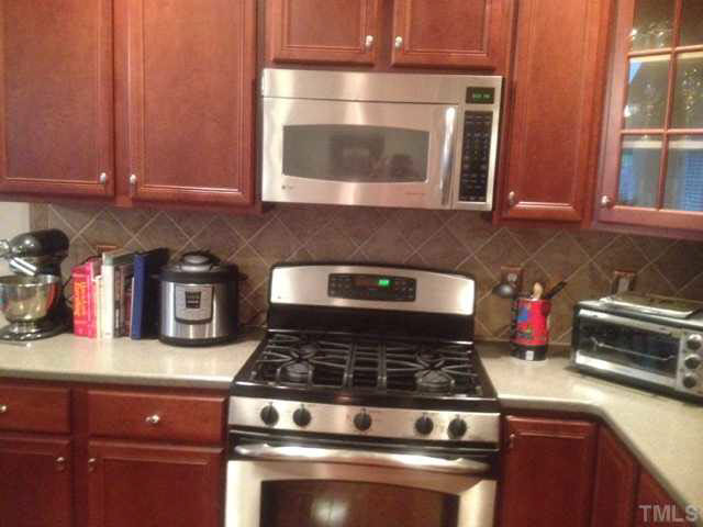 11238 Maplecroft Court Raleigh, NC 27617 - Photo 5 of 12 a stove top oven sitting inside of a kitchen