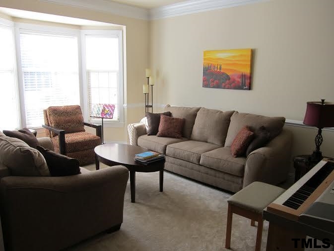 11238 Maplecroft Court Raleigh, NC 27617 - Photo 7 of 12 a living room with furniture and a window