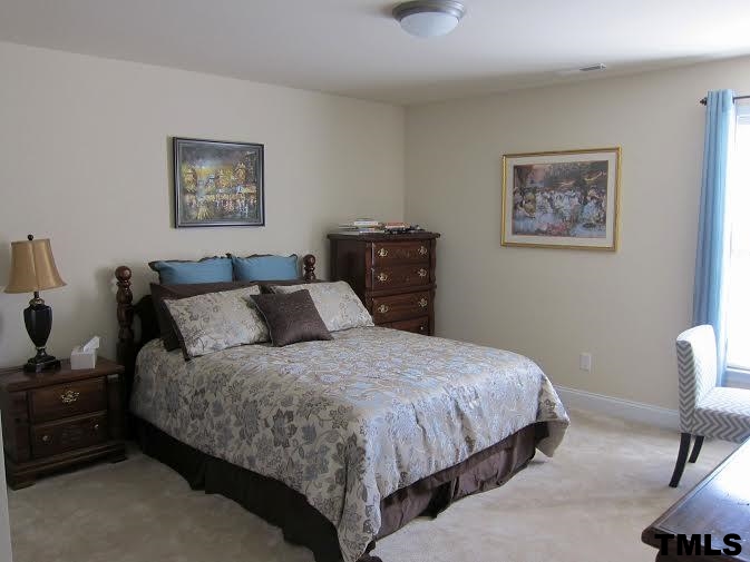 11238 Maplecroft Court Raleigh, NC 27617 - Photo 8 of 12 a bedroom with bed and painting on the wall