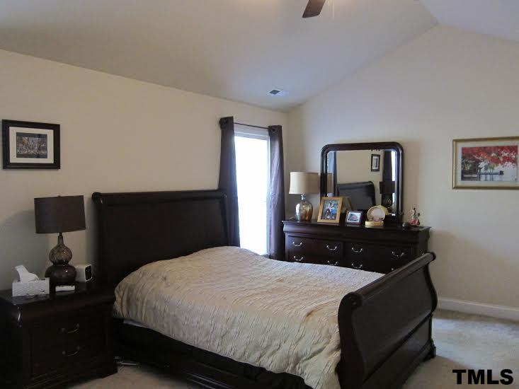 11238 Maplecroft Court Raleigh, NC 27617 - Photo 9 of 12 a bedroom with a bed and a dresser