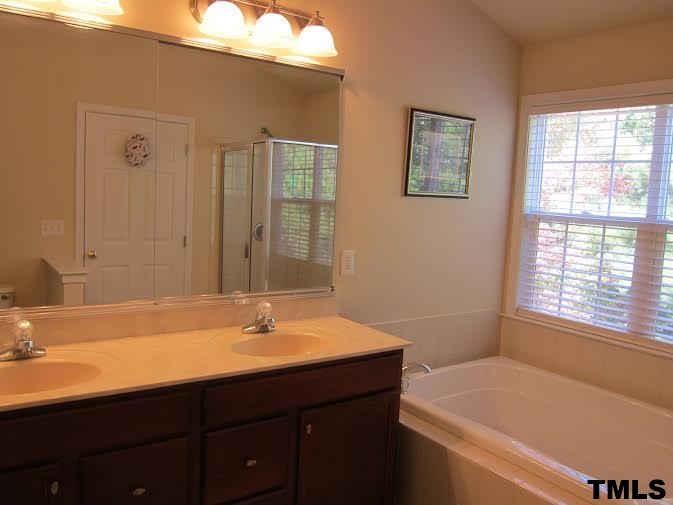 11238 Maplecroft Court Raleigh, NC 27617 - Photo 10 of 12 a bathroom with a sink and a bathtub