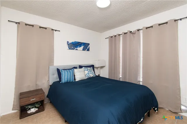 a bedroom with a bed a window and a walk in closet