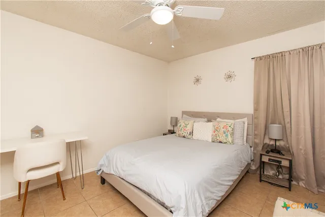 a bedroom with a bed and a chair