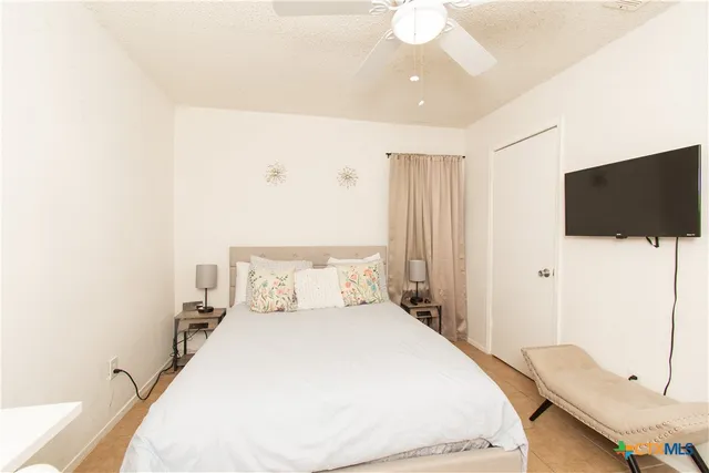 a bedroom with a bed and a flat screen tv