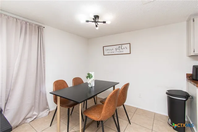 a view of a workspace with furniture and a table