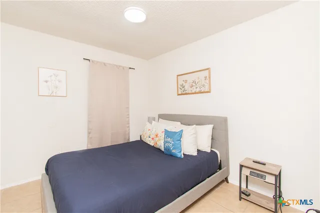 a bed room with a bed and a painting