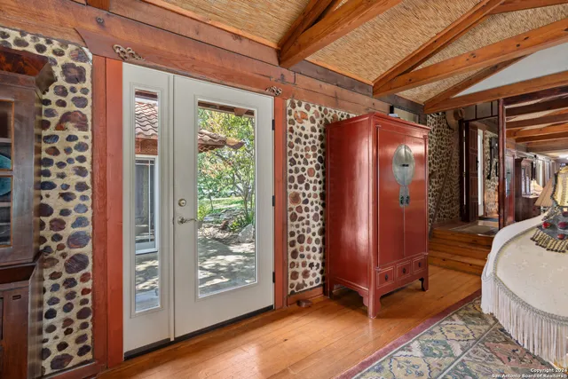 a living room with furniture a fireplace a clock and a large window