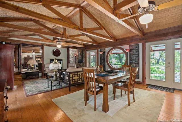 a dining room with furniture a rug and wooden floor
