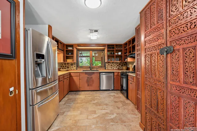 a kitchen with stainless steel appliances granite countertop a stove and a sink