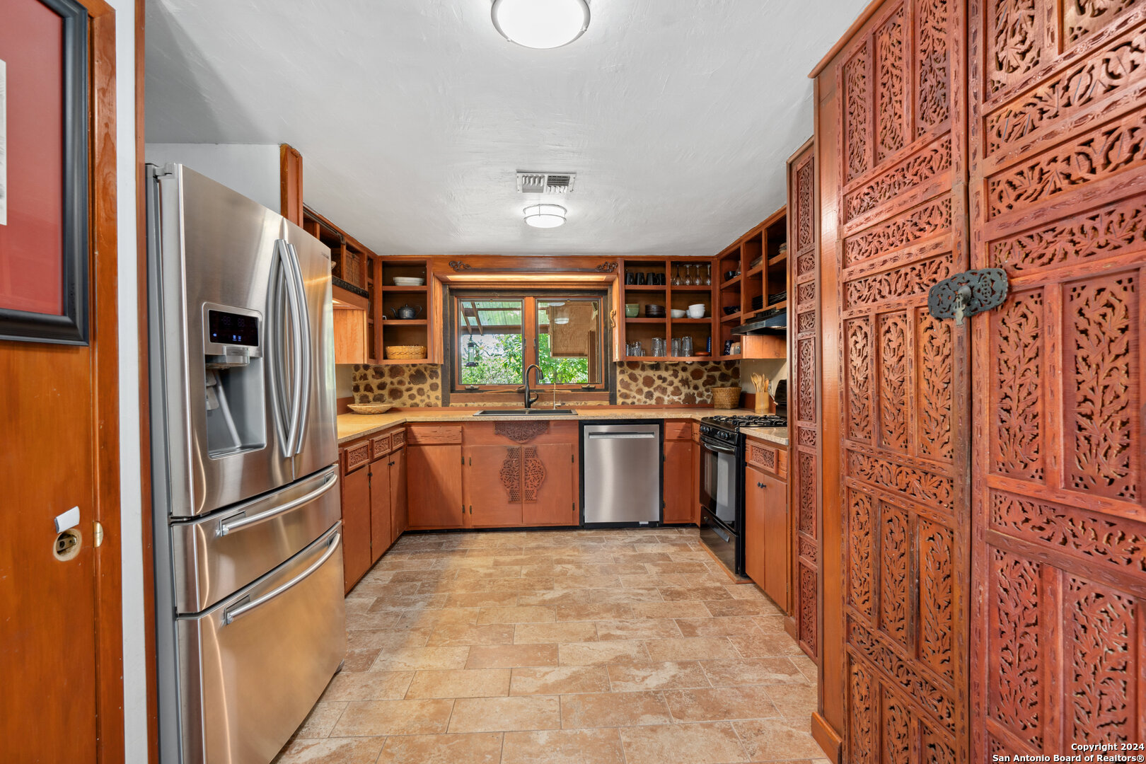 801 Mickle Creek Road Medina, TX 78055 - Photo 22 of 55 a kitchen with stainless steel appliances granite countertop a refrigerator and a sink