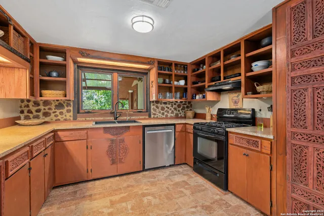 a kitchen with stainless steel appliances granite countertop a stove and a sink