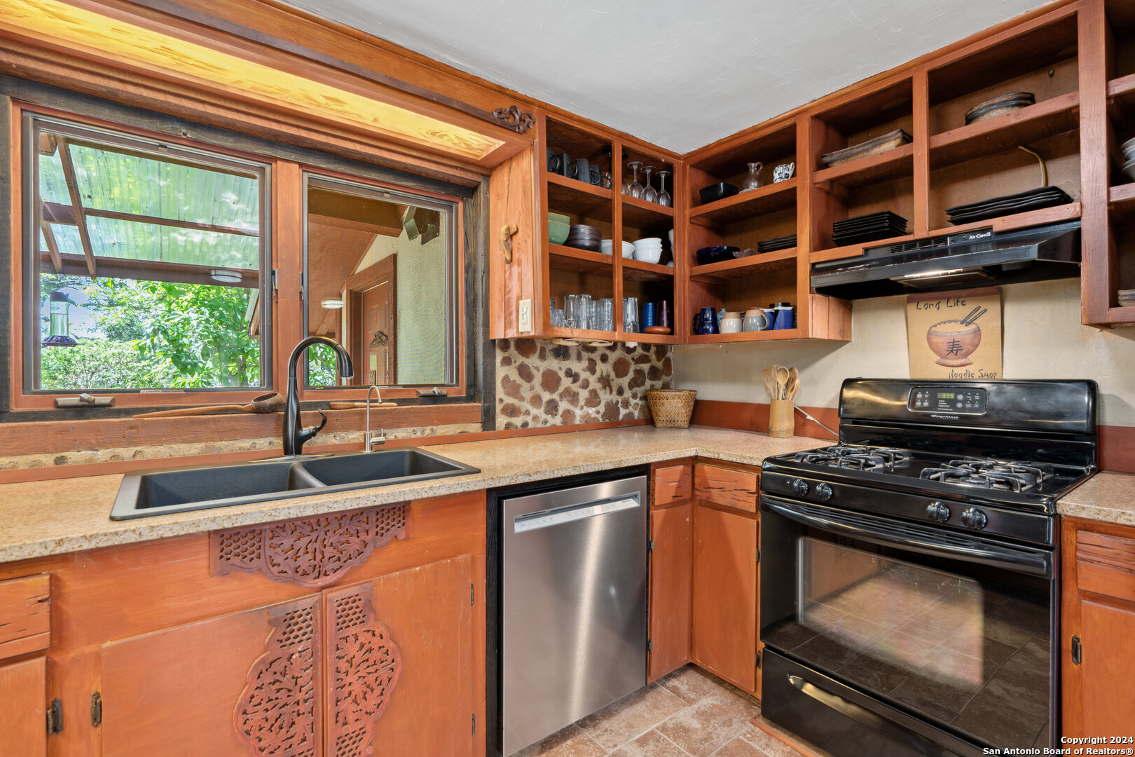 801 Mickle Creek Road Medina, TX 78055 - Photo 24 of 55 a kitchen with stainless steel appliances granite countertop a stove and a sink